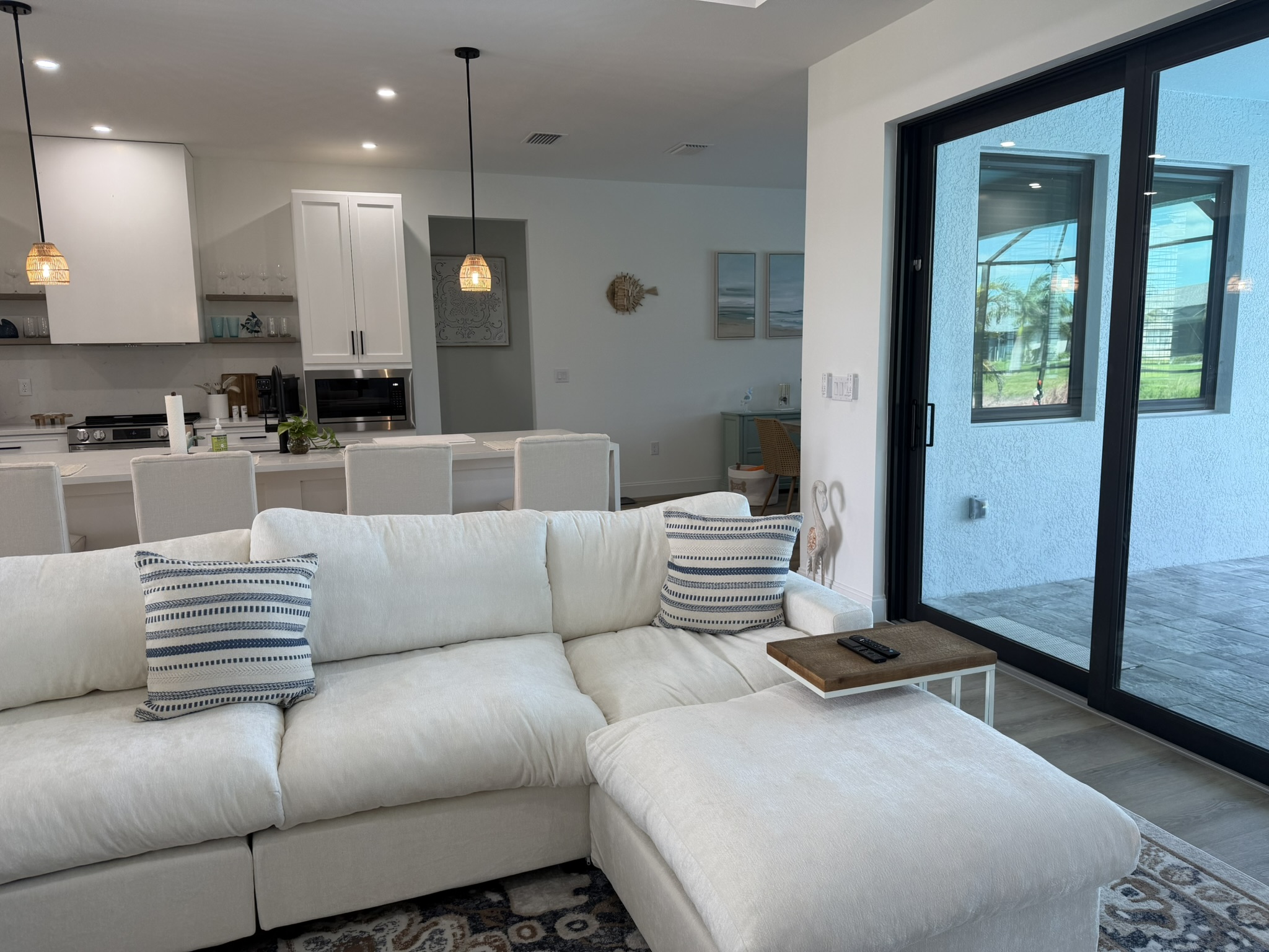 Living room sectional with open kitchen behind