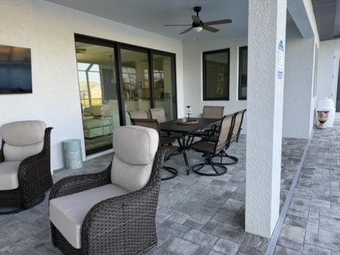 Covered patio with wicker sofa seating