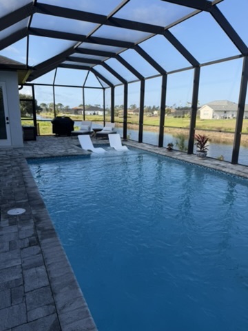 Pool wide angle with canal and palm views