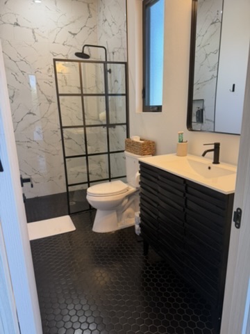Second bathroom with black hex tile and marble shower