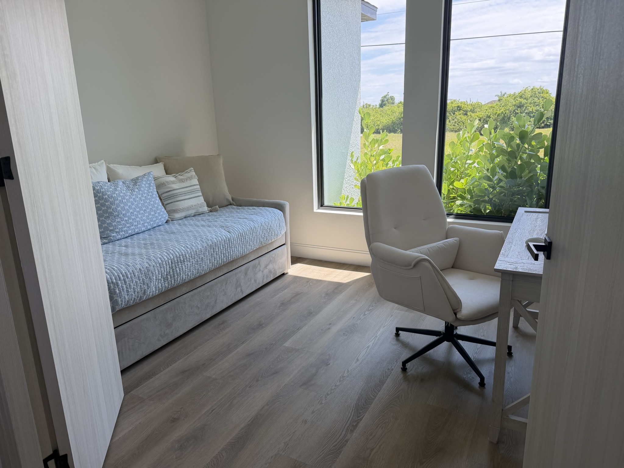 Second bedroom with daybed and desk workspace