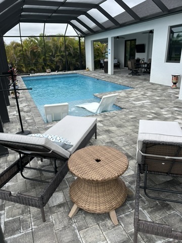 Pool with patio lounge furniture