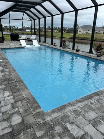 Pool from end with lounge chairs and water views