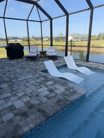 Pool with lounge chairs and water views