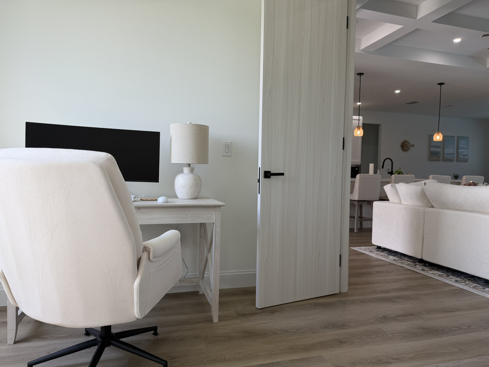 Home office with desk and view to living area