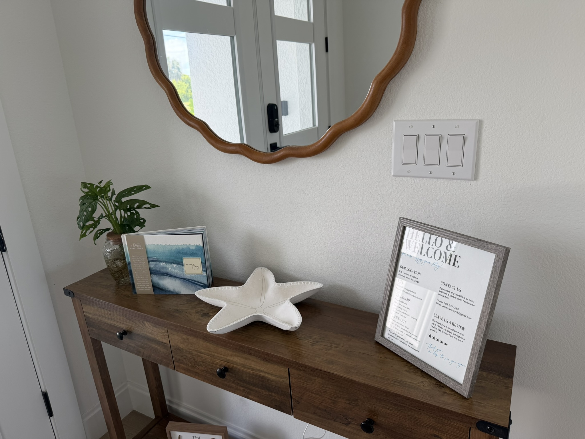 Entryway console with welcome sign and coastal decor
