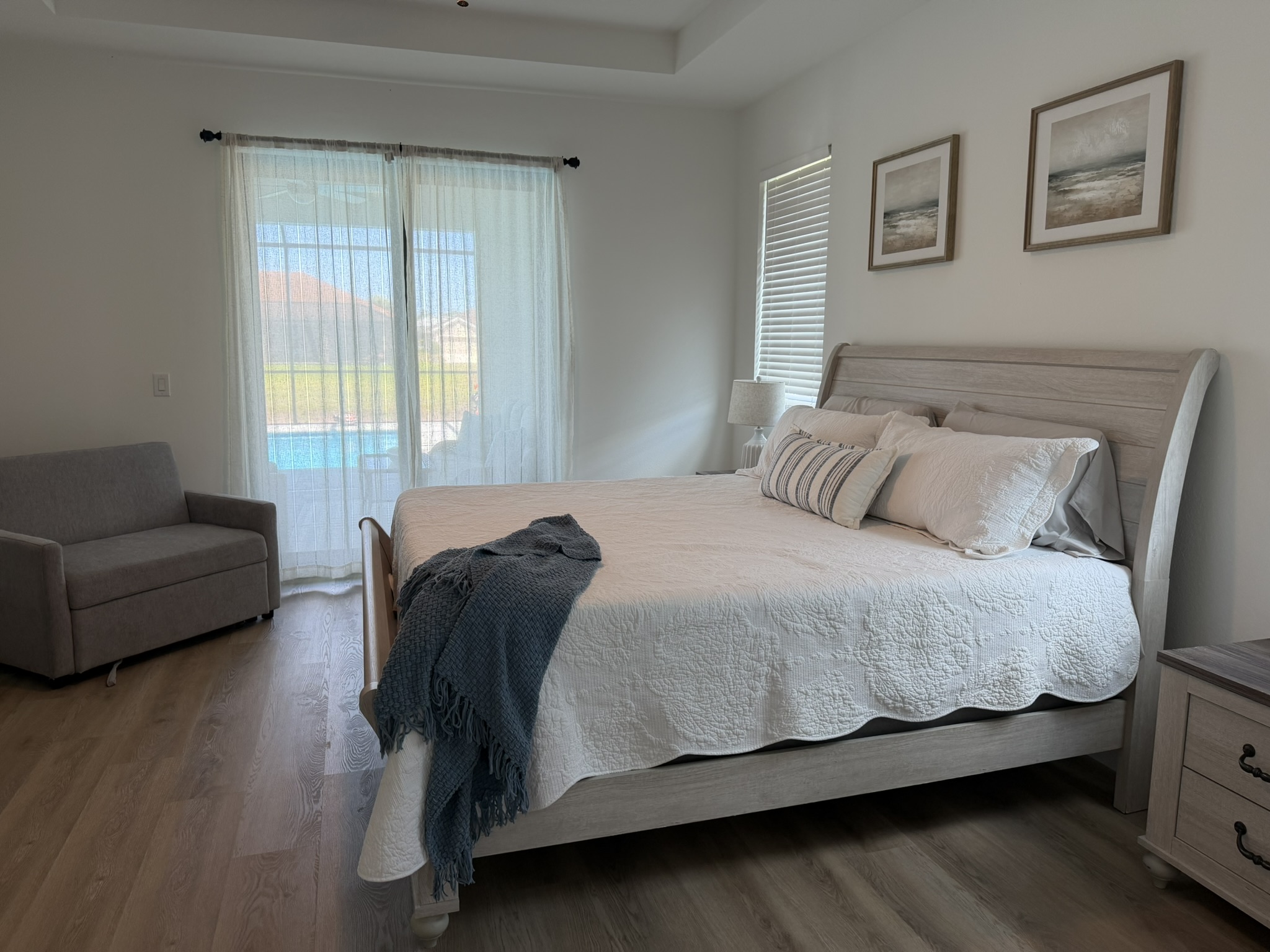 Primary bedroom with king bed and pool view